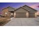 Beautiful home featuring stone accents, a three-car garage, and manicured landscaping at 10145 Deerfield St, Firestone, CO 80504