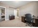 Home office with desk, cabinets, and access to both a bedroom and a bath at 10145 Deerfield St, Firestone, CO 80504