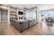 Spacious living room featuring hardwood floors, a ceiling fan, and a stone fireplace at 10145 Deerfield St, Firestone, CO 80504