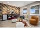 Cozy living room features stylish accent wall, modern furniture, and plenty of natural light at 10145 Deerfield St, Firestone, CO 80504