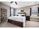 This main bedroom features a ceiling fan, shelves, and two windows that provide natural light at 10145 Deerfield St, Firestone, CO 80504