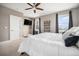 Bright main bedroom offers a ceiling fan, and two windows that let in natural light and a mounted television at 10145 Deerfield St, Firestone, CO 80504