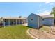 Backyard with a blue shed, covered patio, and green lawn at 7291 Bryant St, Westminster, CO 80030