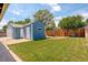View of the backyard with a grassy lawn, shed, and wooden fence, offering a private outdoor space at 7291 Bryant St, Westminster, CO 80030