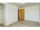 Bedroom with white walls, light wood flooring, and door at 7291 Bryant St, Westminster, CO 80030