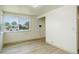 Bedroom with window, white walls, light wood flooring, and closet at 7291 Bryant St, Westminster, CO 80030