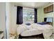 Bedroom with messy bed, light wood flooring, and window with curtains at 7291 Bryant St, Westminster, CO 80030