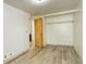 Bedroom with white walls, light wood flooring, and closet with sliding doors at 7291 Bryant St, Westminster, CO 80030