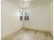 Bedroom with window, white walls, and light wood flooring at 7291 Bryant St, Westminster, CO 80030