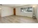 Bright living room with newly installed laminate flooring at 7291 Bryant St, Westminster, CO 80030