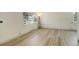 Bright living room featuring large windows and wood-look floors at 7291 Bryant St, Westminster, CO 80030
