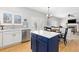 Eat-in kitchen with island, stainless appliances, and adjacent dining area with doors to patio at 9810 Mulberry Way, Highlands Ranch, CO 80129