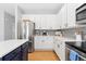 Bright and airy kitchen featuring white cabinets, stainless appliances, and modern backsplash at 9810 Mulberry Way, Highlands Ranch, CO 80129