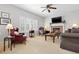 Comfortable living room with fireplace, neutral carpet, and lots of natural light at 9810 Mulberry Way, Highlands Ranch, CO 80129