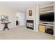Cozy living room with a fireplace, built-in shelves, and comfortable seating at 9810 Mulberry Way, Highlands Ranch, CO 80129