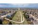 This aerial shot features a green space bordered by suburban houses with a sidewalk running through it at 6431 Freeport Dr, Highlands Ranch, CO 80130
