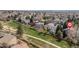 This aerial view shows several homes next to a green space in a suburban neighborhood at 6431 Freeport Dr, Highlands Ranch, CO 80130