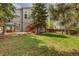 Backyard features mature trees, a spacious lawn, and access to the home at 6431 Freeport Dr, Highlands Ranch, CO 80130