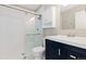 This is a bathroom with a glass-doored shower and navy vanity at 6431 Freeport Dr, Highlands Ranch, CO 80130