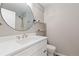 Bathroom featuring a round mirror, white vanity and a walk-in shower at 6431 Freeport Dr, Highlands Ranch, CO 80130