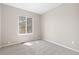 A bedroom with a window view and neutral-colored carpet and paint at 6431 Freeport Dr, Highlands Ranch, CO 80130