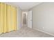 An empty bedroom with neutral paint, carpet, and a bright yellow curtain at 6431 Freeport Dr, Highlands Ranch, CO 80130