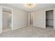 Empty bedroom featuring an ensuite bathroom, closet and carpet at 6431 Freeport Dr, Highlands Ranch, CO 80130