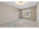 This bedroom is well lit with neutral paint, carpet and window view at 6431 Freeport Dr, Highlands Ranch, CO 80130