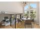 View of the dining area featuring large windows, hardwood floors and contemporary light fixture at 6431 Freeport Dr, Highlands Ranch, CO 80130