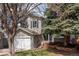 Beautiful 2-story home with an attached garage, blue front door and established trees at 6431 Freeport Dr, Highlands Ranch, CO 80130