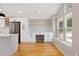Open floorplan with white cabinets and stainless appliances in this beautifully remodeled kitchen at 6431 Freeport Dr, Highlands Ranch, CO 80130