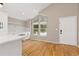 Bright kitchen and dining room features white cabinets, lots of light and hardwood floors at 6431 Freeport Dr, Highlands Ranch, CO 80130