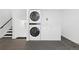 Efficient laundry area featuring a stacked washer and dryer, plus additional storage space with a freezer at 6431 Freeport Dr, Highlands Ranch, CO 80130