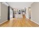 Open concept living room showcasing hardwood floors and connectivity to the kitchen and stairs at 6431 Freeport Dr, Highlands Ranch, CO 80130
