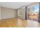 Sunlit living room with hardwood floors that lead to a private balcony through sliding glass doors at 6431 Freeport Dr, Highlands Ranch, CO 80130
