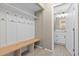 Functional mudroom with built-in bench and hooks, conveniently located next to a well-lit bathroom at 6431 Freeport Dr, Highlands Ranch, CO 80130
