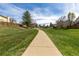 A sidewalk path stretches through a lush green lawn in the neighborhood at 6431 Freeport Dr, Highlands Ranch, CO 80130