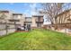 Spacious fenced backyard featuring a wood deck and well-maintained lawn, perfect for outdoor enjoyment at 12606 Fairfax St, Thornton, CO 80241