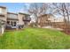 Expansive backyard featuring a wooden deck, comfortable seating, grill, and lush green lawn at 12606 Fairfax St, Thornton, CO 80241