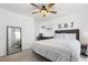 Serene bedroom with a plush bed, modern decor, and a stylish mirror, creating a relaxing and inviting space at 12606 Fairfax St, Thornton, CO 80241