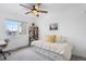 Bright bedroom with neutral color palette, daybed with built-in storage, and large window with neighborhood views at 12606 Fairfax St, Thornton, CO 80241