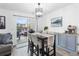 Cozy dining room with a stylish table, seating, and sliding door access to the outdoor patio area at 12606 Fairfax St, Thornton, CO 80241