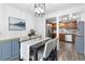 Modern dining room featuring a stylish table and chairs, plus contemporary lighting and access to an updated kitchen at 12606 Fairfax St, Thornton, CO 80241