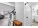 Bright entryway featuring hardwood floors, staircase, and a conveniently located half bathroom at 12606 Fairfax St, Thornton, CO 80241