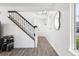 Welcoming entryway with hardwood floors, staircase and modern lighting at 12606 Fairfax St, Thornton, CO 80241
