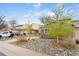 Home featuring a brick facade, driveway, and low-maintenance rock landscaping at 12606 Fairfax St, Thornton, CO 80241
