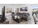 Comfortable living room with hardwood floors, modern sofa, and natural light at 12606 Fairfax St, Thornton, CO 80241