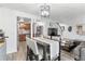 Open-concept living space featuring a dining area and access to a modern kitchen for seamless entertaining and daily living at 12606 Fairfax St, Thornton, CO 80241