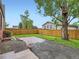 Fenced backyard with a brick patio and gravel area offers privacy and space for outdoor enjoyment at 1351 Brentwood St, Lakewood, CO 80214
