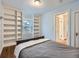 Comfortable bedroom featuring built-in shelving, hardwood floors, and an inviting atmosphere at 1351 Brentwood St, Lakewood, CO 80214